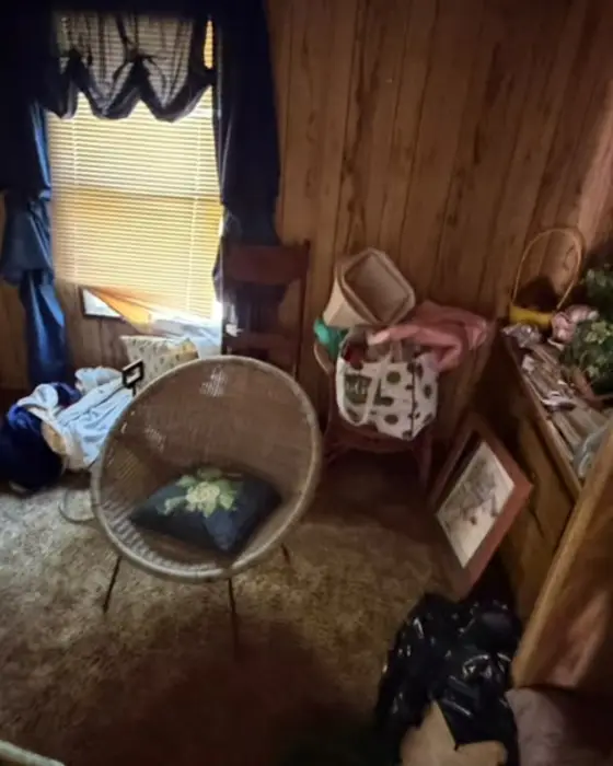Dark room piled with bags and clutter