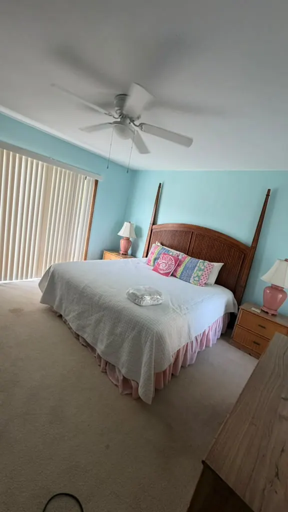 Bedroom with a made bed and a clean floor