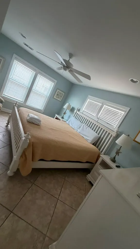 Bedroom with white bedding and a clean floor