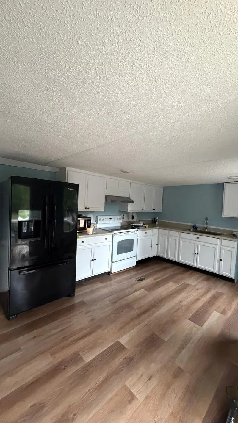 Clean, tidy white kitchen with wood floors